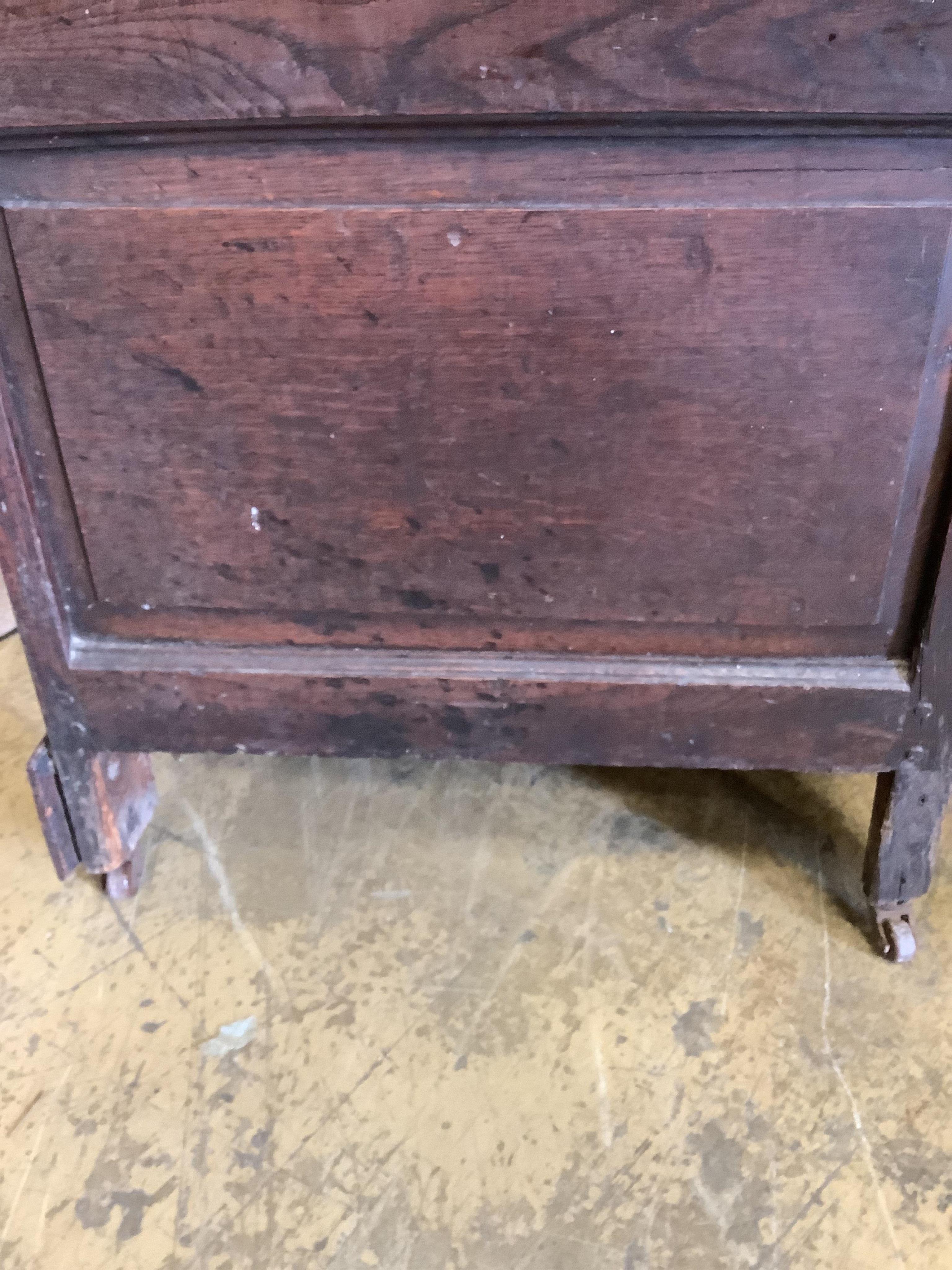 An 18th century panelled oak mule chest, adapted, width 152cm, depth 54cm, height 92cm. Condition - fair